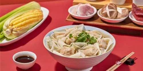 The red-and-white sign of a Ji Xiang Wontons shop marked 24 hours